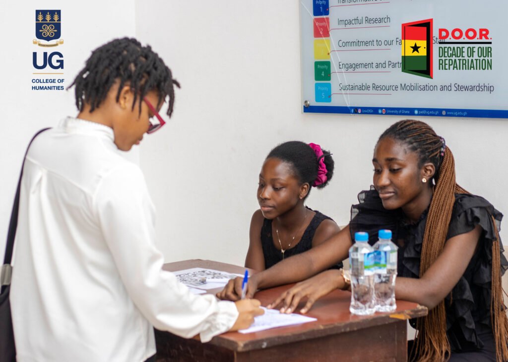 Students engaging with an information table at the Open D.O.O.R. Dialogues launch